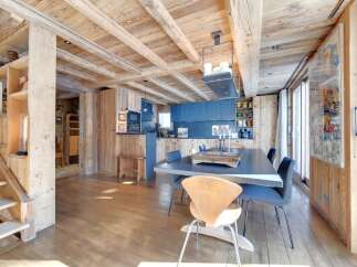 Experience rustic elegance in this stunning property, featuring a warm wooden interior and exposed beams.