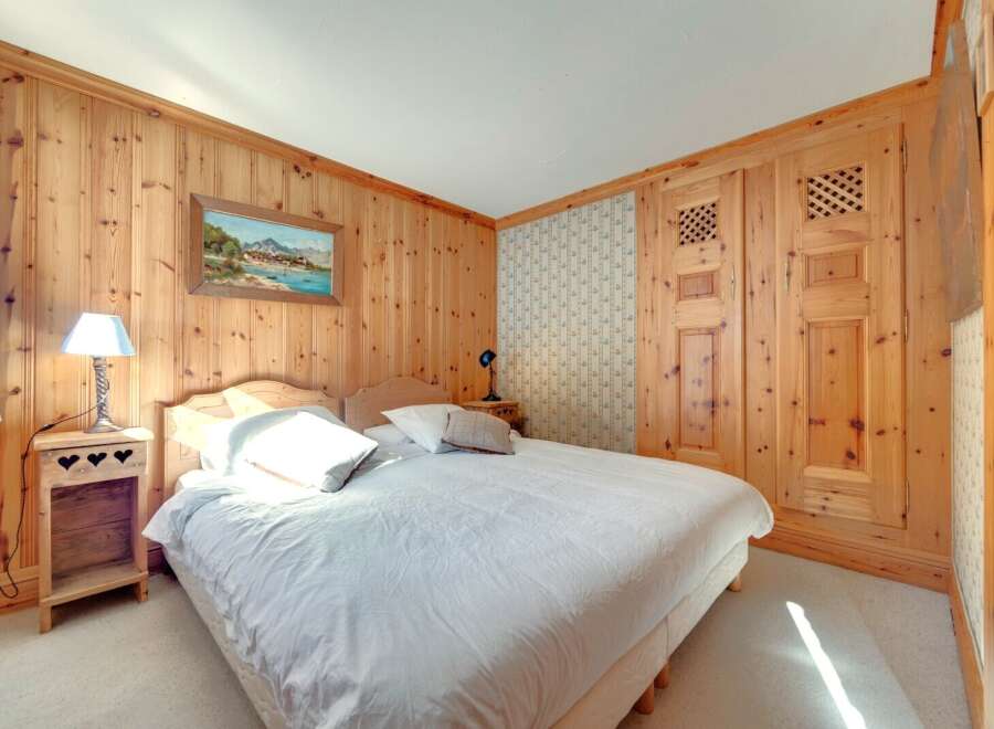 This cozy bedroom features beautiful wood paneling throughout, creating a warm and inviting atmosphere.