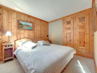 This cozy bedroom features beautiful wood paneling throughout, creating a warm and inviting atmosphere.