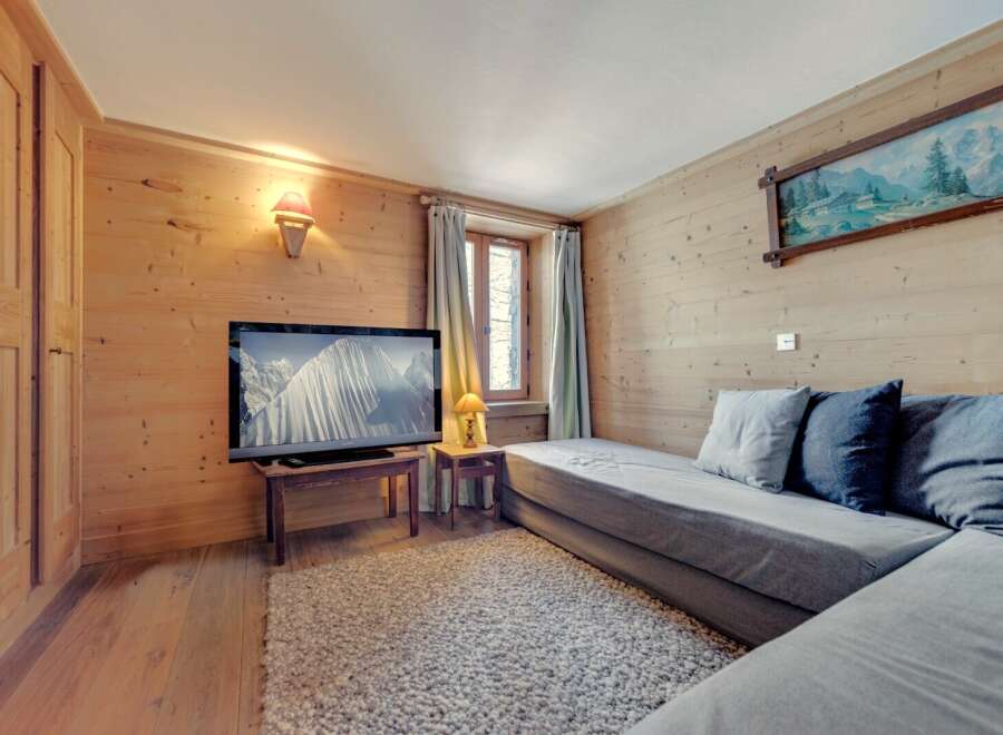 This cozy living space features beautiful wood paneling and a comfortable seating area, perfect for relaxing.