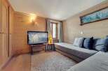 This cozy living space features beautiful wood paneling and a comfortable seating area, perfect for relaxing.