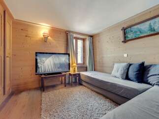 This cozy living space features beautiful wood paneling and a comfortable seating area, perfect for relaxing.