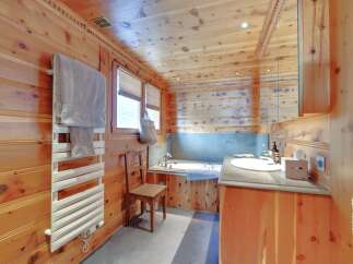 This stunning bathroom boasts a warm and inviting ambiance with its natural wood paneling.