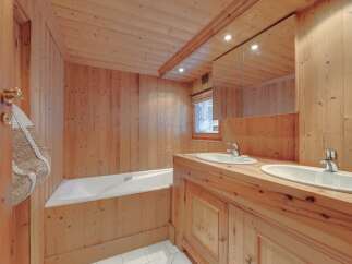 This stunning bathroom showcases a warm, inviting ambiance with its all-wood paneling.