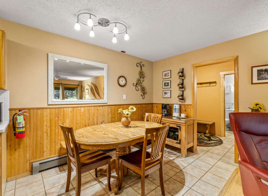 This charming dining area features a rustic wooden table and chairs, perfect for enjoying meals with family and friends.