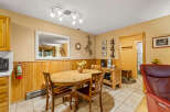 This charming dining area features a rustic wooden table and chairs, perfect for enjoying meals with family and friends.