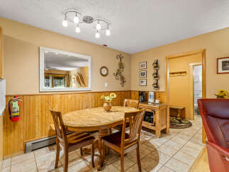 This charming dining area features a rustic wooden table and chairs, perfect for enjoying meals with family and friends.