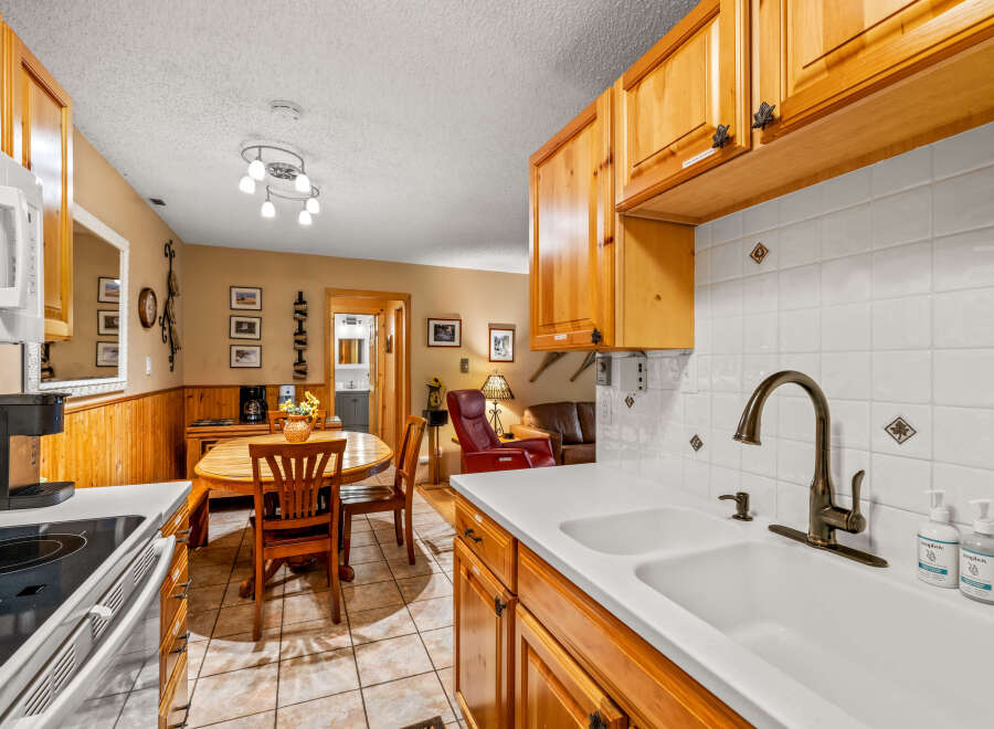 This charming kitchen features warm wooden cabinetry and a bright, inviting atmosphere.