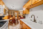 This charming kitchen features warm wooden cabinetry and a bright, inviting atmosphere.