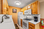 This charming kitchen boasts warm wooden cabinetry and a bright, inviting atmosphere.