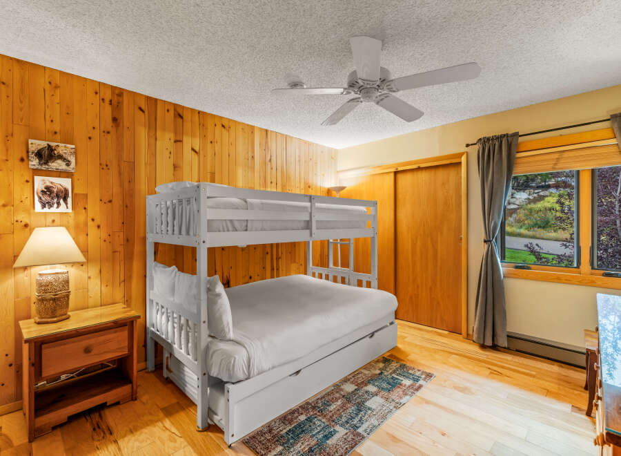 This cozy bedroom features a charming bunk bed, perfect for accommodating guests or family members.