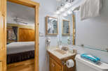 This charming bathroom features a well-lit vanity area with a mirror, perfect for your morning routine.