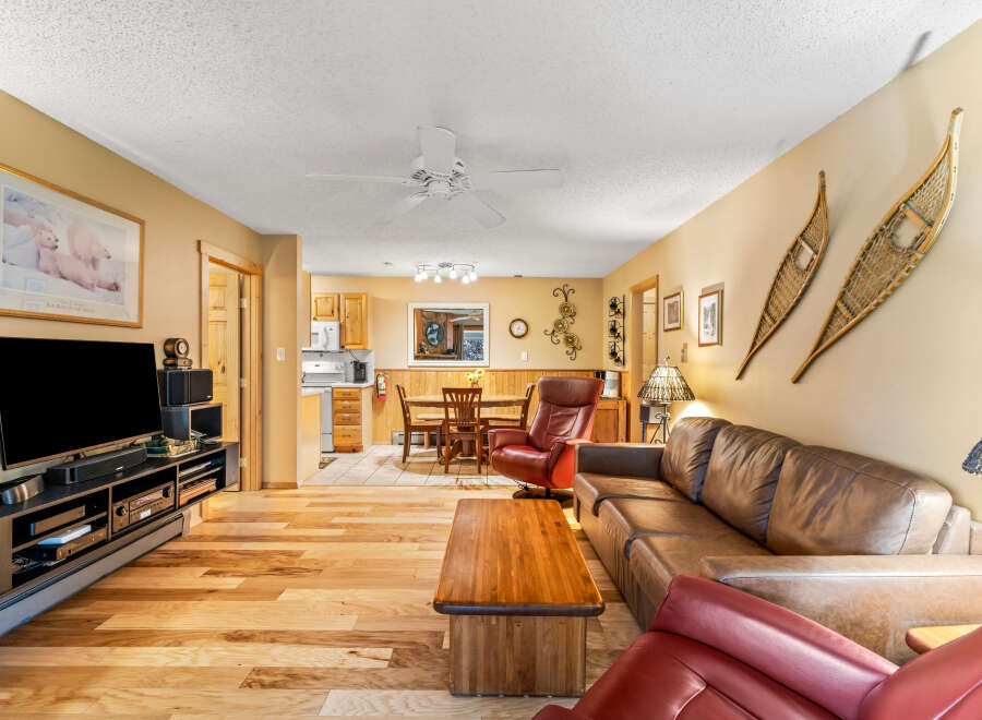 Step into this inviting living space, featuring warm wood flooring and a cozy ambiance.