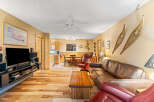 Step into this inviting living space, featuring warm wood flooring and a cozy ambiance.