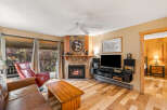 This cozy living room features a stunning stone fireplace, perfect for those chilly evenings.