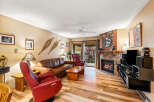 This cozy living room features a stunning stone fireplace, perfect for those chilly evenings.