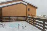 Enjoy a relaxing soak in the hot tub with stunning views of the snow-covered mountains.