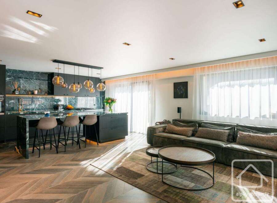 Experience luxury living in this stunning property, featuring a modern kitchen with sleek countertops and a stylish island.