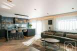 Experience luxury living in this stunning property, featuring a modern kitchen with sleek countertops and a stylish island.