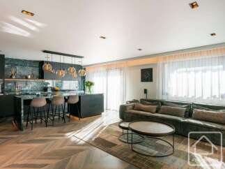 Experience luxury living in this stunning property, featuring a modern kitchen with sleek countertops and a stylish island.
