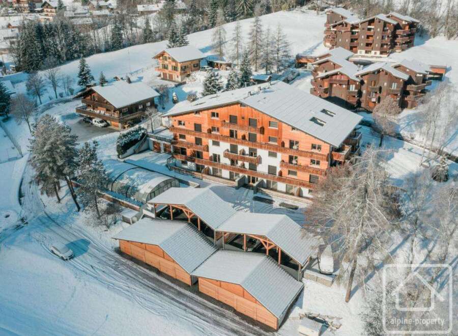Discover a stunning alpine property nestled in a picturesque winter wonderland.