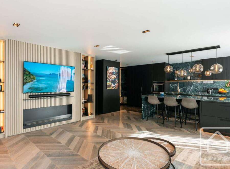 Experience luxury living in this stunning property! Featuring a modern kitchen with sleek countertops and stylish bar stools, perfect for entertaining.
