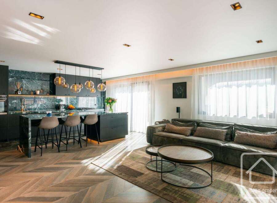 Experience luxury living in this stunning property, featuring a modern kitchen with sleek countertops and a stylish island.