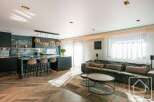 Experience luxury living in this stunning property, featuring a modern kitchen with sleek countertops and a stylish island.
