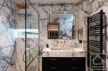 Experience luxury in this stunning bathroom featuring exquisite marble finishes.
