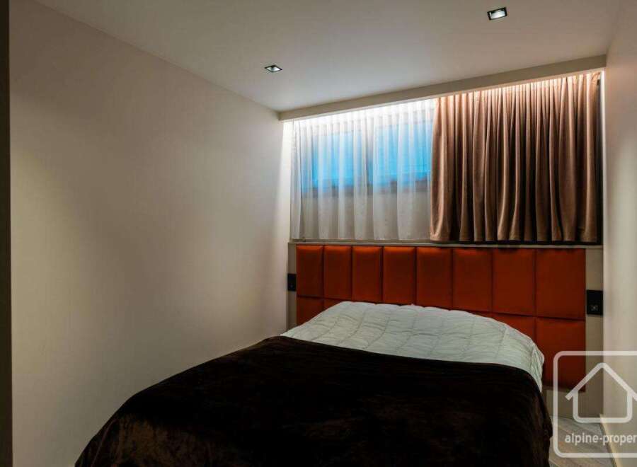 Experience luxury in this stunning bedroom featuring a modern design and elegant decor.