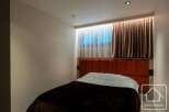 Experience luxury in this stunning bedroom featuring a modern design and elegant decor.