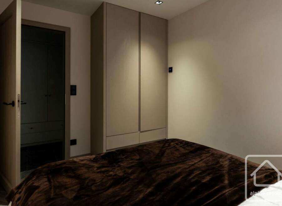 This bedroom features a modern design with a focus on simplicity and functionality.