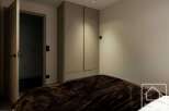 This bedroom features a modern design with a focus on simplicity and functionality.