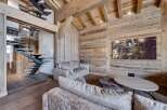 Experience rustic elegance in this stunning property, featuring exquisite wooden paneling and a modern staircase.