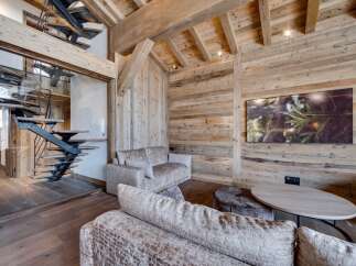 Experience rustic elegance in this stunning property, featuring exquisite wooden paneling and a modern staircase.