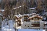 Discover the charm of this stunning mountain chalet, nestled amidst a snowy landscape.