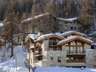 Discover the charm of this stunning mountain chalet, nestled amidst a snowy landscape.