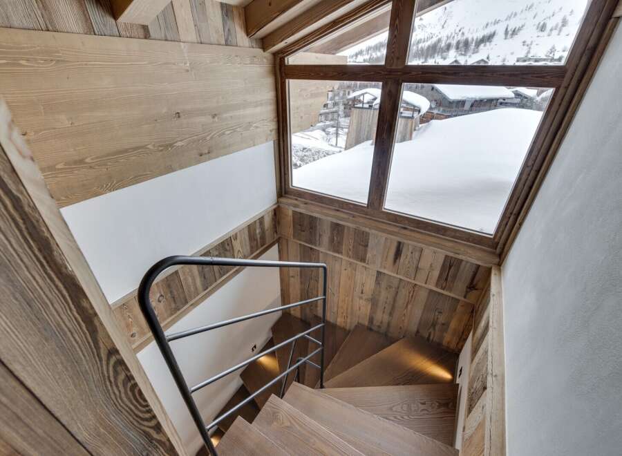 This stunning property boasts a beautifully crafted wooden staircase, creating a warm and inviting atmosphere.