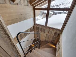 This stunning property boasts a beautifully crafted wooden staircase, creating a warm and inviting atmosphere.