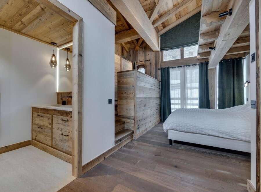 Experience rustic elegance in this stunning property, featuring a master bedroom with a unique wooden ceiling and walls.
