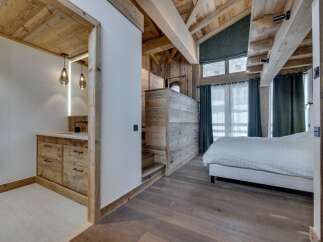 Experience rustic elegance in this stunning property, featuring a master bedroom with a unique wooden ceiling and walls.