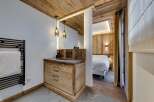 Experience rustic elegance in this stunning property, featuring a beautifully designed bathroom with a wooden vanity and modern fixtures.