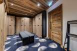 Step into luxury with this stunning locker room, featuring custom wooden lockers and a unique moon-themed carpet.