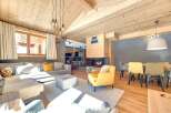 Experience the warmth of this stunning living space, featuring a cozy fireplace and a stylish yellow armchair.