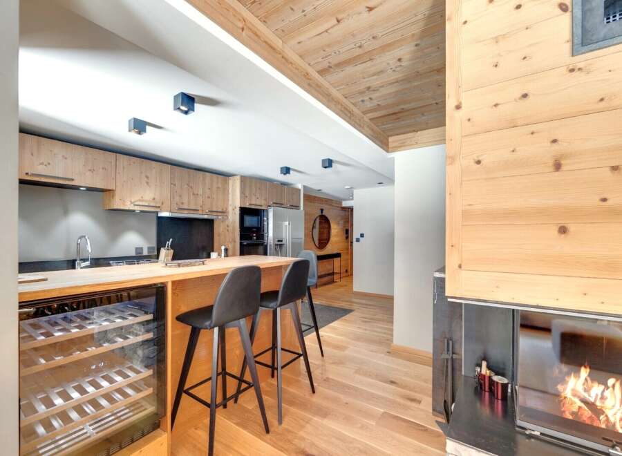 This stunning property boasts a modern kitchen with sleek cabinetry and a convenient wine cooler, perfect for entertaining.