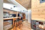 This stunning property boasts a modern kitchen with sleek cabinetry and a convenient wine cooler, perfect for entertaining.