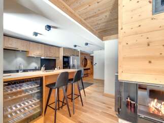 This stunning property boasts a modern kitchen with sleek cabinetry and a convenient wine cooler, perfect for entertaining.