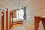 This cozy bedroom features a warm wooden interior, creating a serene and inviting atmosphere.