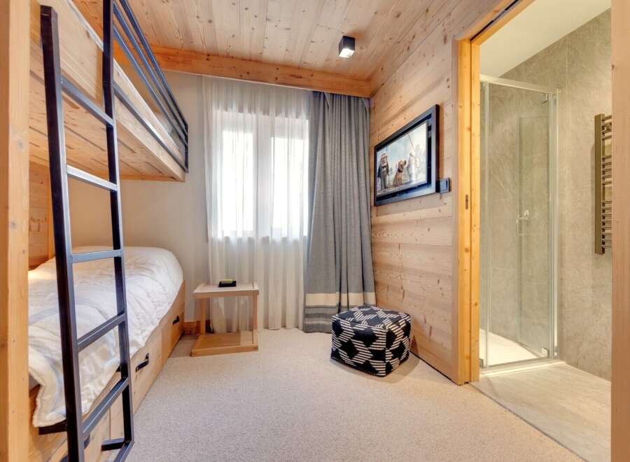 This cozy bedroom features a bunk bed, perfect for accommodating guests or family members.