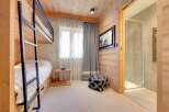 This cozy bedroom features a bunk bed, perfect for accommodating guests or family members.